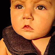 Joshua joined the competition — help win amazing prizes! baby, child, closeup, cute, dark_background, expression, eyelashes, eyes, face, harness, head, human, infant, portrait, serious, skin, straps, sunlight, warm_light, young