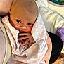 Hazely is registered to the contest to win money with this photo: baby, newborn, infant, blanket, pink, heart_pattern, hands, face, eyes, person, skin, arm, cradle, bed, adult, human, soft, cute, tender, closeup