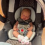 Hazely is registered to the contest to win money with this photo: baby, infant, car_seat, sleeping, polka_dot, sock, straps, indoor, child, newborn, seat, clothing, person, floor, fabric, head, peaceful, cute, rest, safety