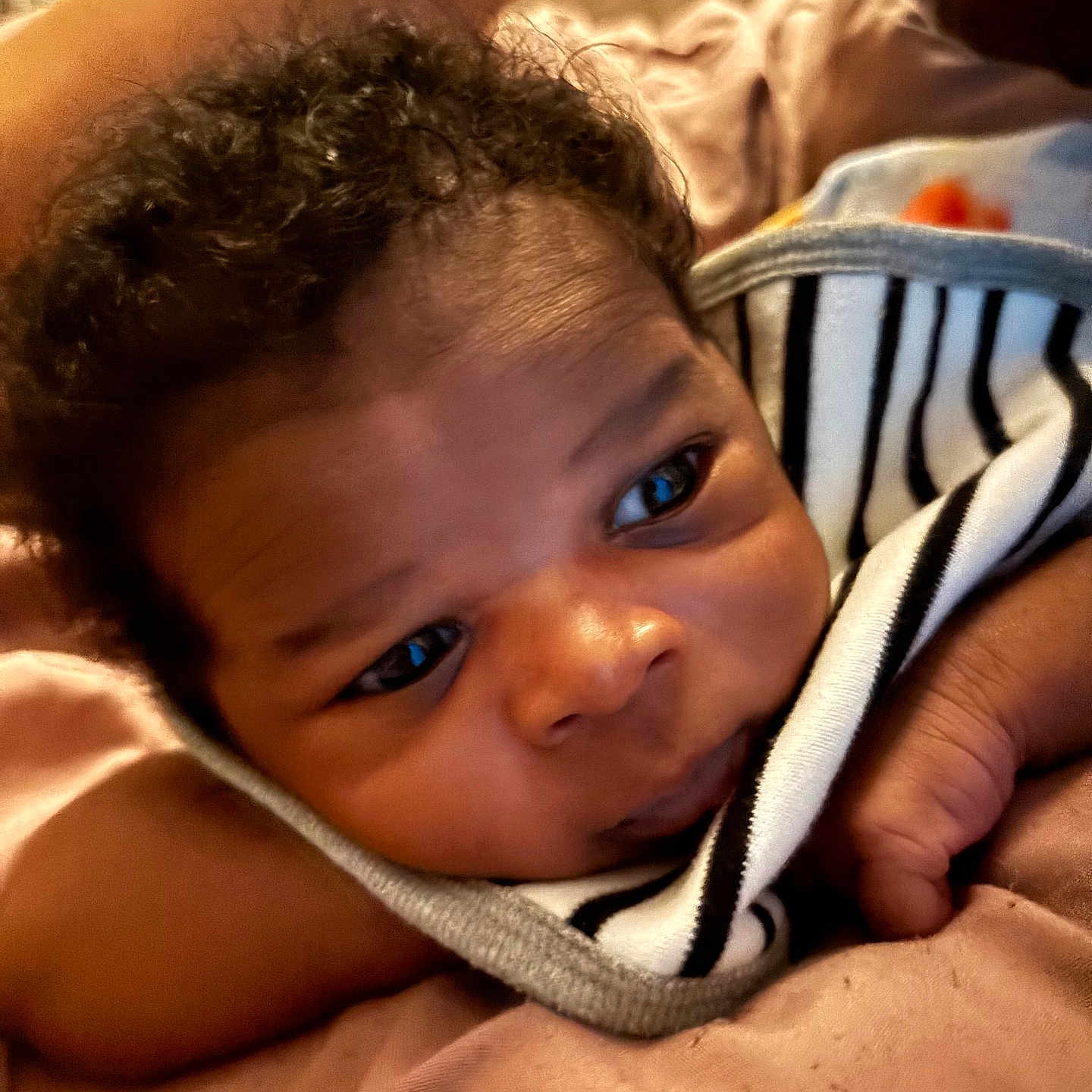 Mykel is registered to the contest to win money with this photo: baby, bed, blanket, bodypart, cushion, face, finger, furniture, hand, happy, head, homedecor, indoors, newborn, person, photography, portrait, quilt, smile, towel