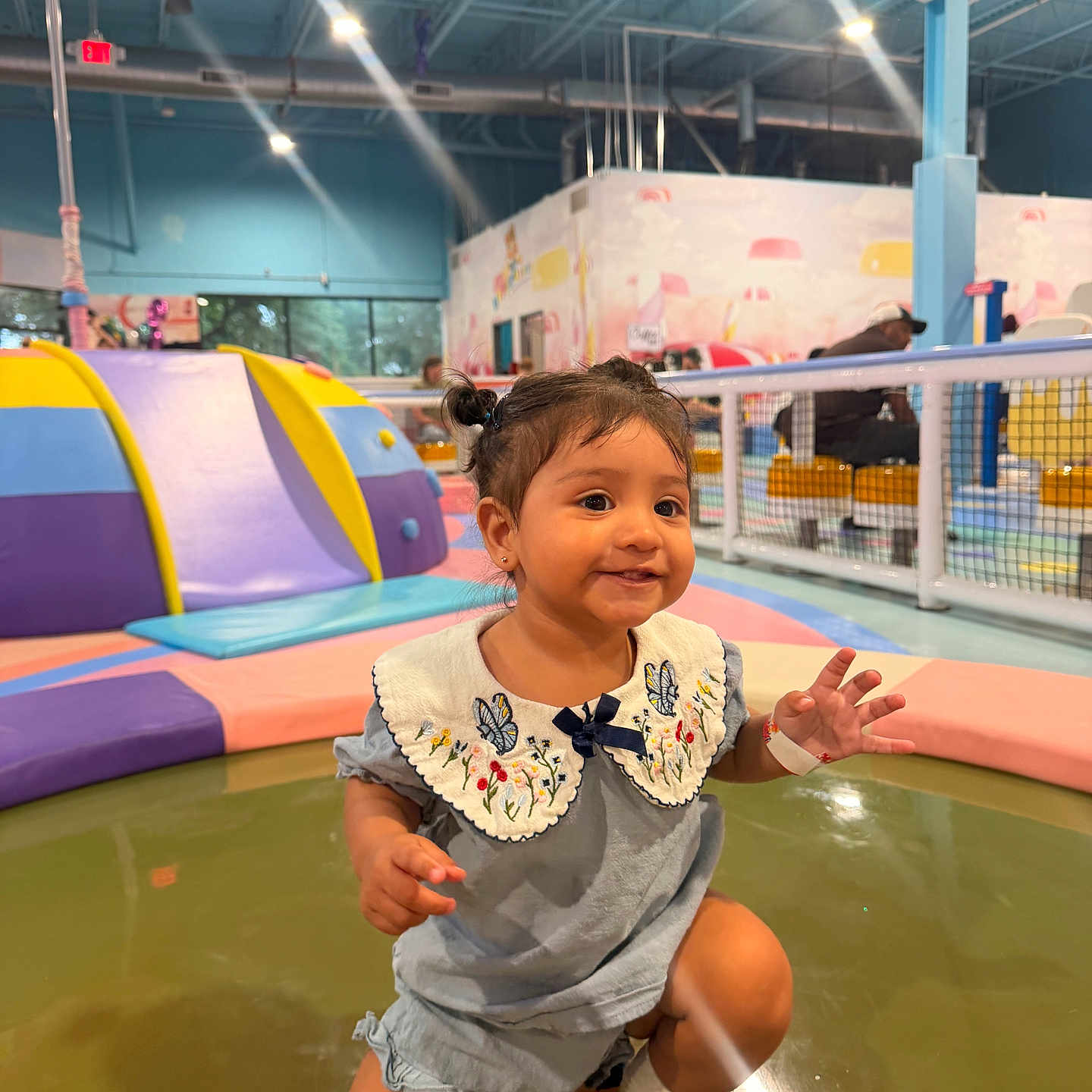 Amanda is registered to the contest to win money with this photo: toddler, child, indoor_play_area, colorful, playground, soft_play, pigtails, smiling, cute, floor, clothing, collar, socks, person, play, fun, happy, young_child, baby, play_equipment