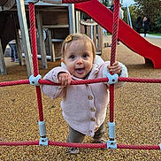 Lyvia participe au concours pour gagner de l'argent avec cette photo : toddler, child, playground, climbing_rope, red_rope, outdoor, play_equipment, slide, smiling, cute, happy, knitted_jacket, buttoned_jacket, ground_surface, fall_clothing, toy, person, baby, fun, daylight