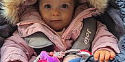 Lyvia participe au concours pour gagner de l'argent avec cette photo : baby, child, stroller, jacket, hood, fur, blanket, toy, pacifier, hand, face, clothing, cold_weather, infant, cute, bundle, seated, portrait, indoors, warm