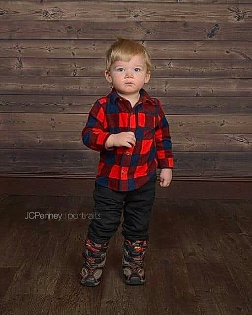 Daemon is registered to the contest to win money with this photo: child, child_model, design, male, outerwear, pattern, person, plaid, sleeve, standing, tartan, toddler, trousers, wood