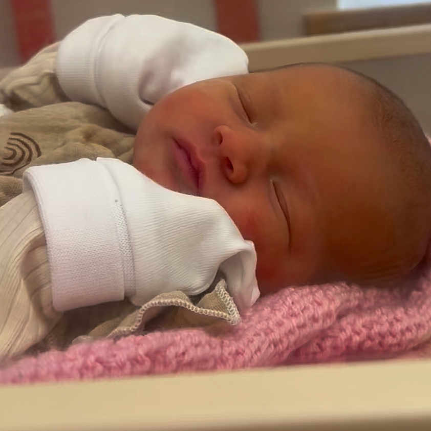 Elira Rae joined the competition — help win amazing prizes! baby, blanket, clothing, cozy, cute, face, head, indoors, infant, mittens, newborn, peaceful, person, portrait, rest, skin, sleep, sleeping, soft, toddler