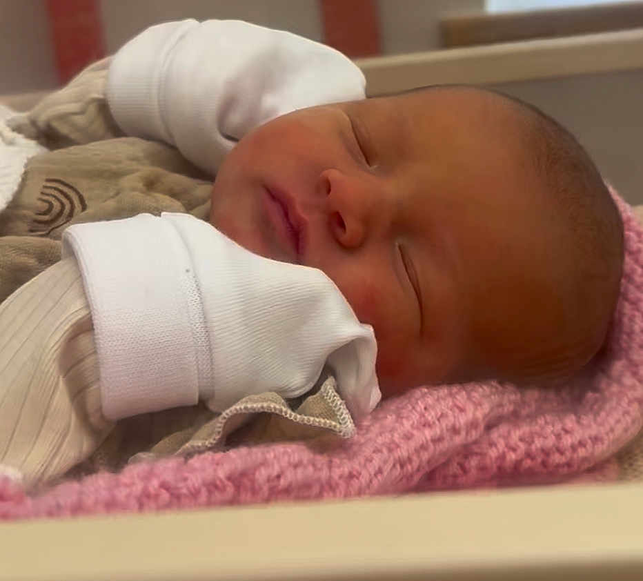 Elira Rae joined the competition — help win amazing prizes! baby, newborn, sleeping, infant, blanket, mittens, clothing, face, head, person, rest, soft, cozy, indoors, cute, peaceful, skin, portrait, toddler, sleep