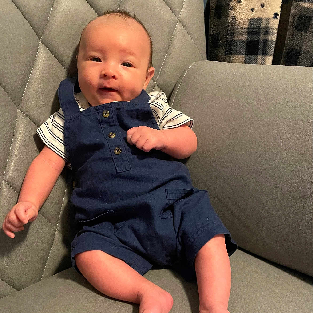 Jameson is registered to the contest to win money with this photo: baby, bodypart, chair, clothing, couch, cushion, face, finger, furniture, hand, head, homedecor, jeans, pants, person, photography, portrait, shirt, shorts, sitting