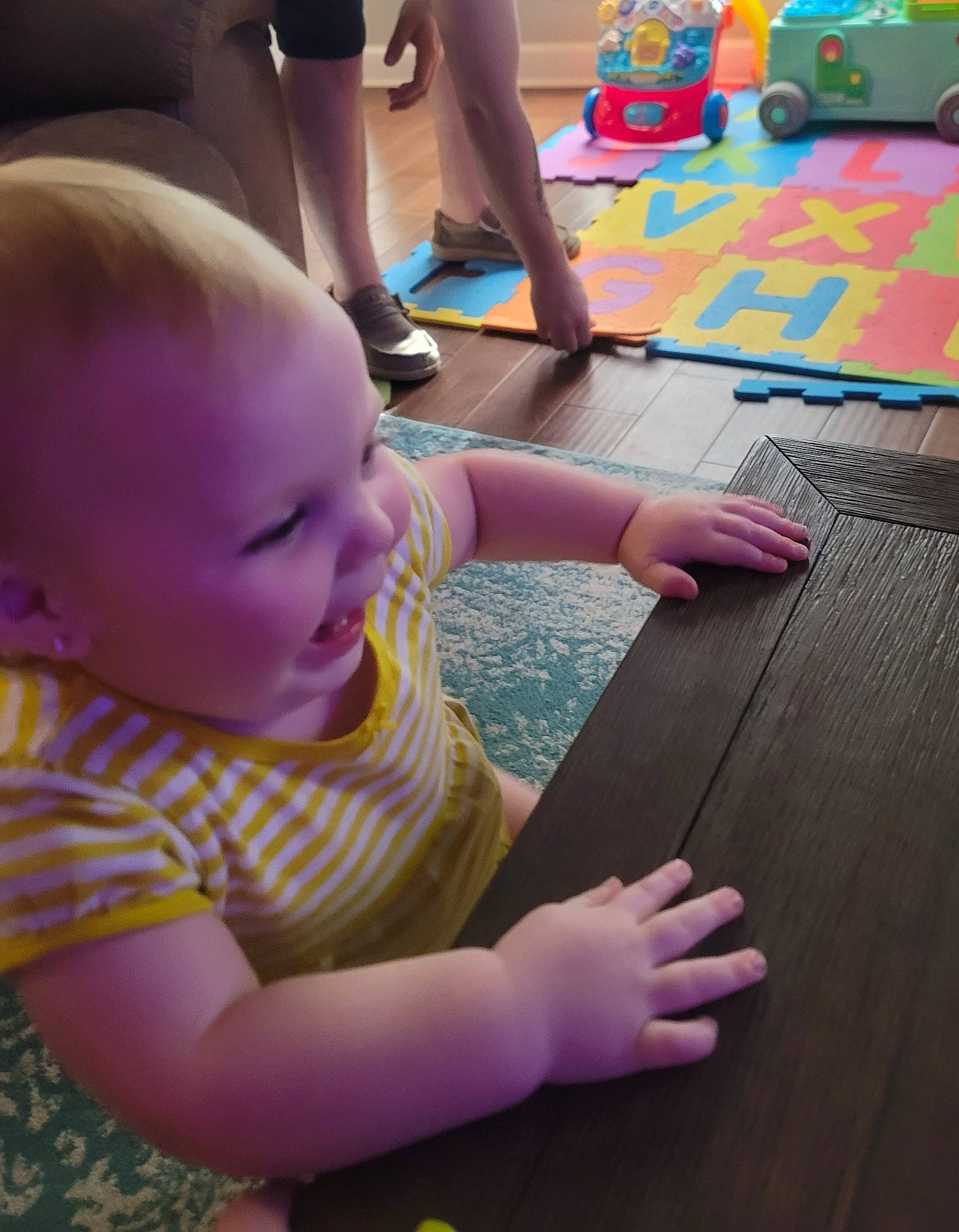 Lillith is registered to the contest to win money with this photo: baby, baby_toddler_clothing, black, child, finger, floor, flooring, fun, hand, joint, leg, light, mammal, person, photograph, pink, purple, skin, smile, standing