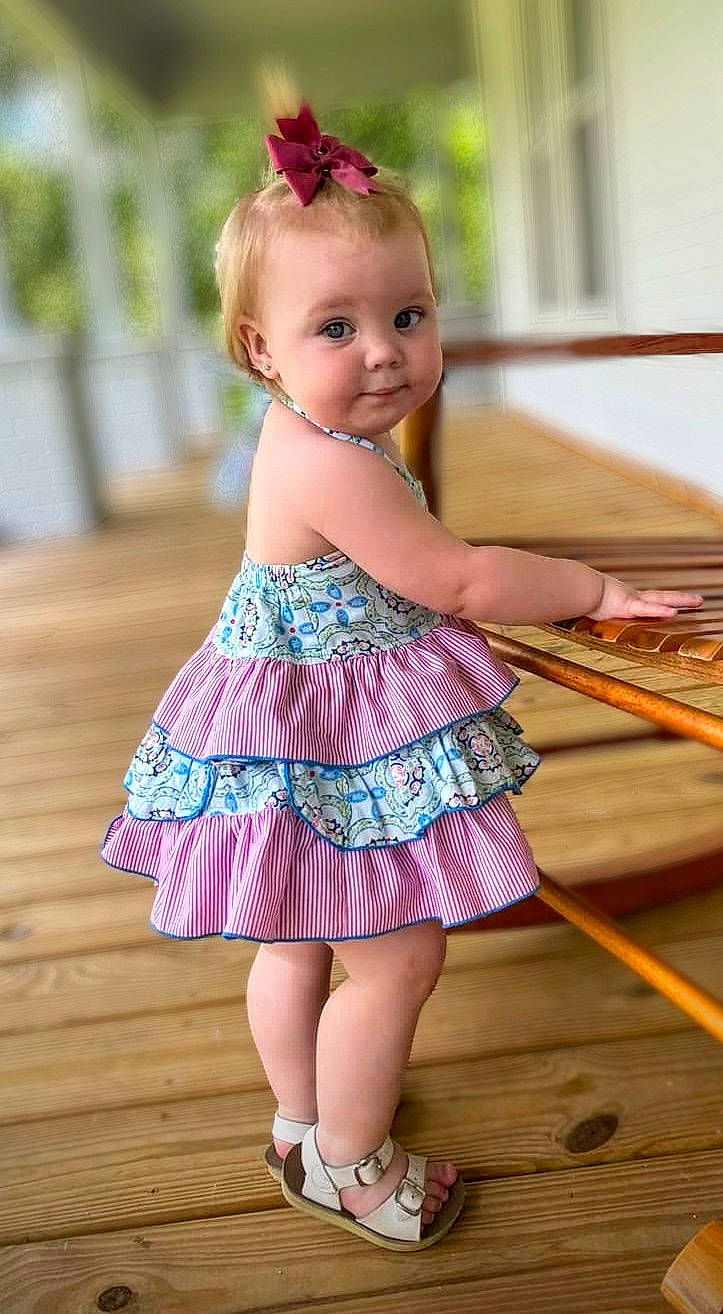Lillith joined the competition — help win amazing prizes! baby_toddler_clothing, blond, child, day_dress, dress, eye, face, happy, iris, magenta, one_piece_garment, pattern, person, pink, purple, skin, smile, toddler, violet, waist
