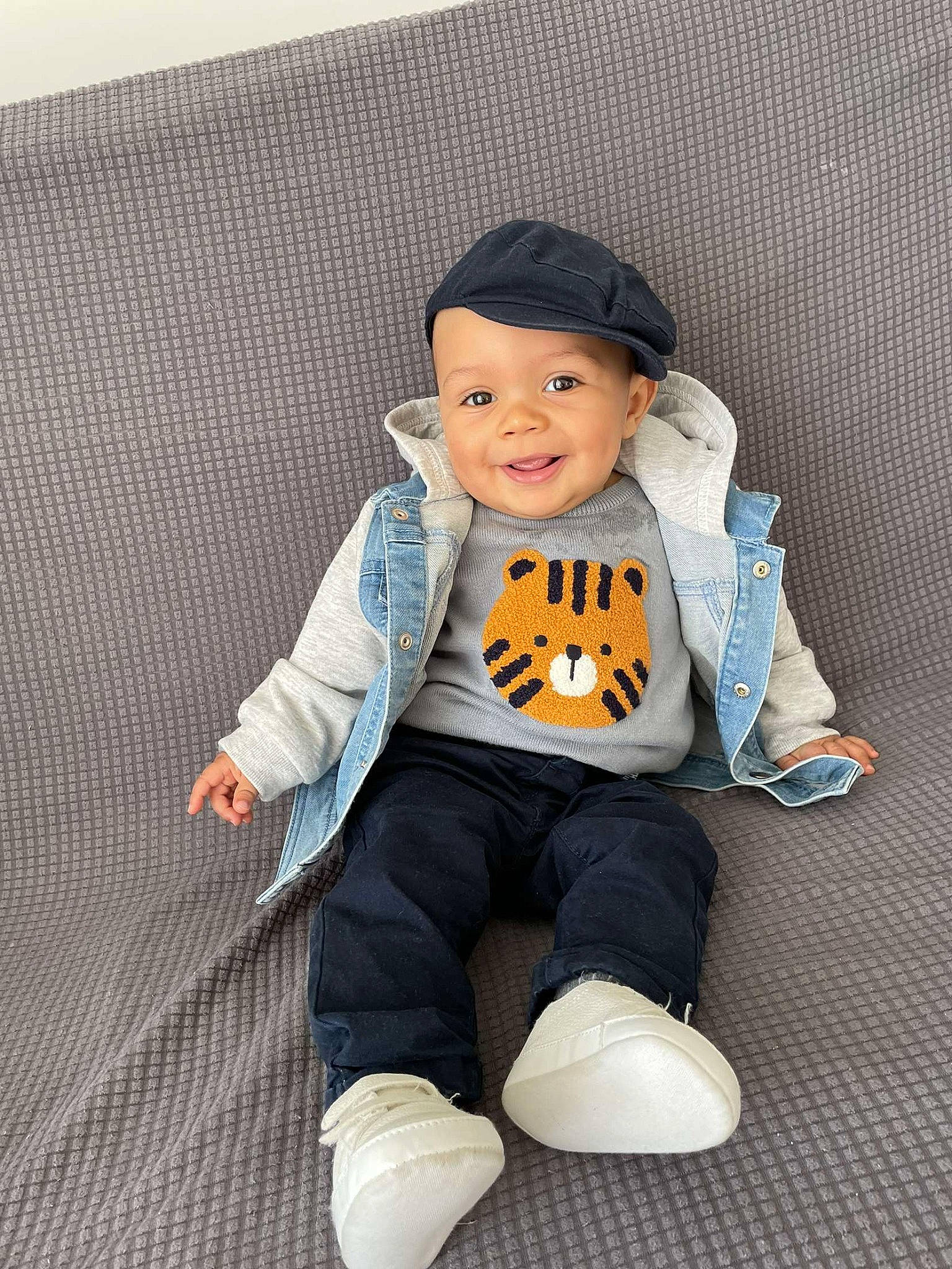 Kelani participe au concours pour gagner de l'argent avec cette photo : baby, baby_toddler_clothing, cap, child, collar, comfort, denim, eye, face, happy, hat, headwear, jacket, joy, outerwear, person, sitting, sleeve, smile, street_fashion