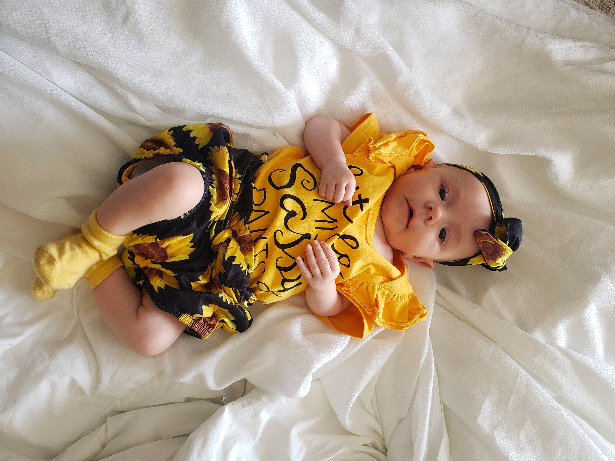 Elora is registered to the contest to win money with this photo: baby, baby_sleeping, baby_toddler_clothing, bed, bedding, child, comfort, eye, finger, foot, hand, happy, hat, head, headwear, human_leg, linens, person, room, skin