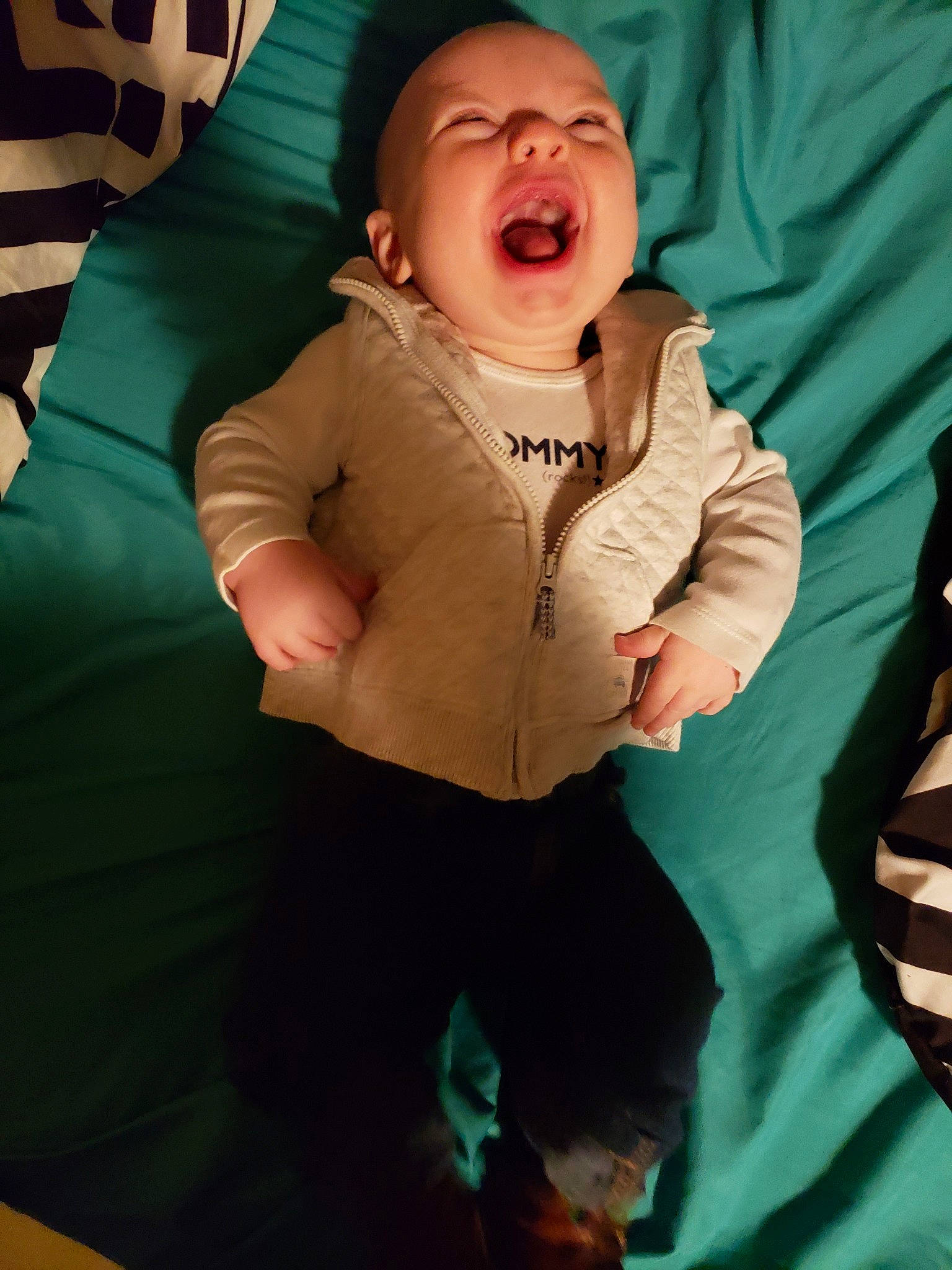 Brennan joined the competition — help win amazing prizes! arm, baby, child, facial_expression, finger, fun, gesture, green, hand, laugh, mouth, person, sitting, smile, thumb, toddler