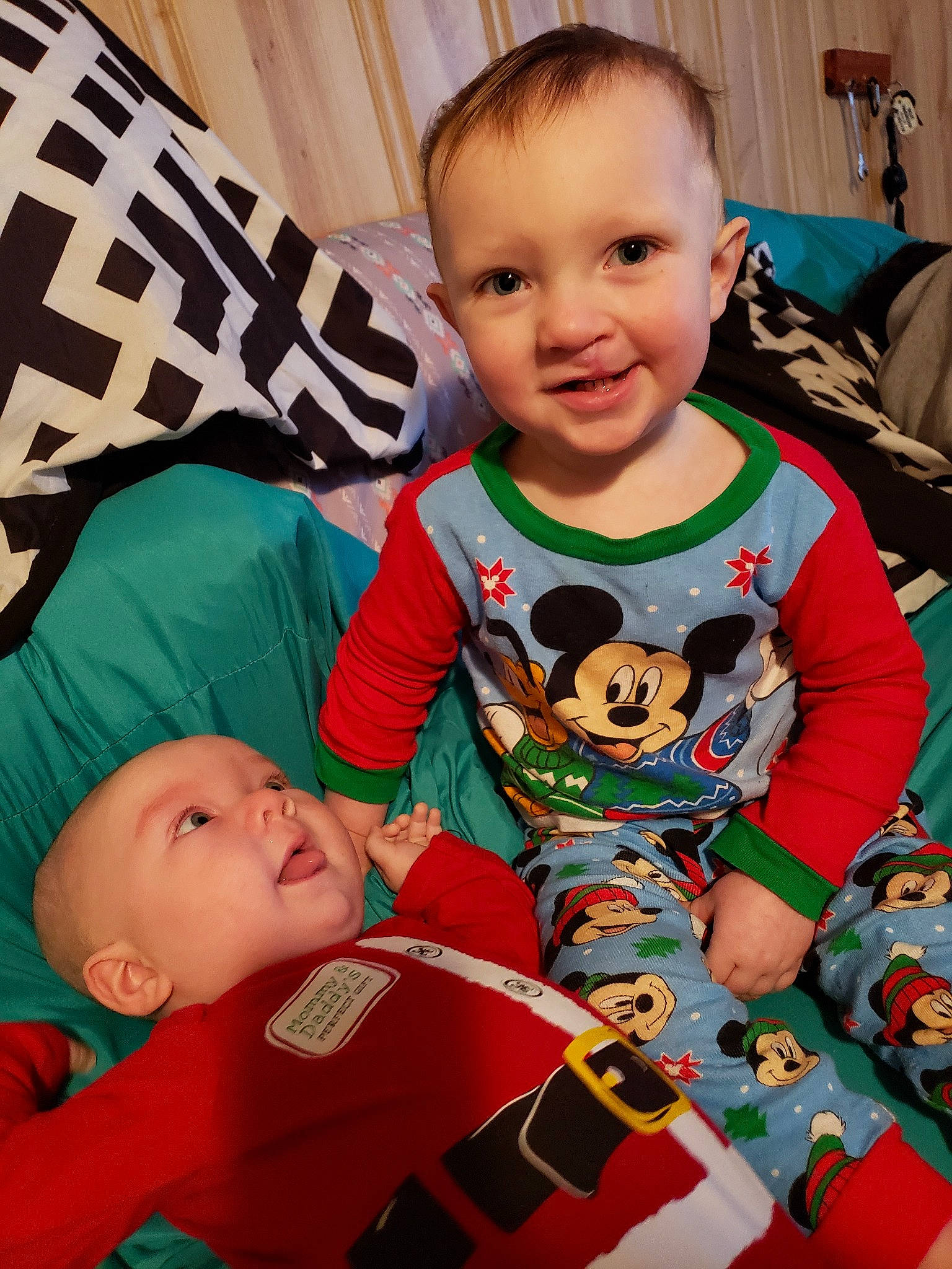 Bryce is registered to the contest to win money with this photo: baby, cheek, child, face, fictional_character, head, person, play, room, sibling, skin, sleeve, smile, toddler