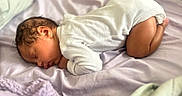 Zymirah is registered to the contest to win money with this photo: baby, sleeping, infant, onesie, blanket, bed, curled_up, soft, peaceful, newborn, cute, child, skin, head, ear, face, rest, indoors, comfort, toddler