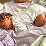 baby, sleeping, infant, onesie, blanket, bed, curled_up, soft, peaceful, newborn, cute, child, skin, head, ear, face, rest, indoors, comfort, toddler