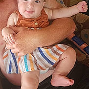 Juliana is registered to the contest to win money with this photo: baby, child, headband, bow, dress, striped, arms, adult, smile, happy, indoor, person, skin, legs, hand, furniture, seated, cute, portrait, comfort