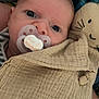 baby, pacifier, blanket, closeup, face, infant, child, plush_toy, fabric, texture, cute, comfort, resting, indoor, portrait, young_child, soft, wrapped, eyes, nurtured