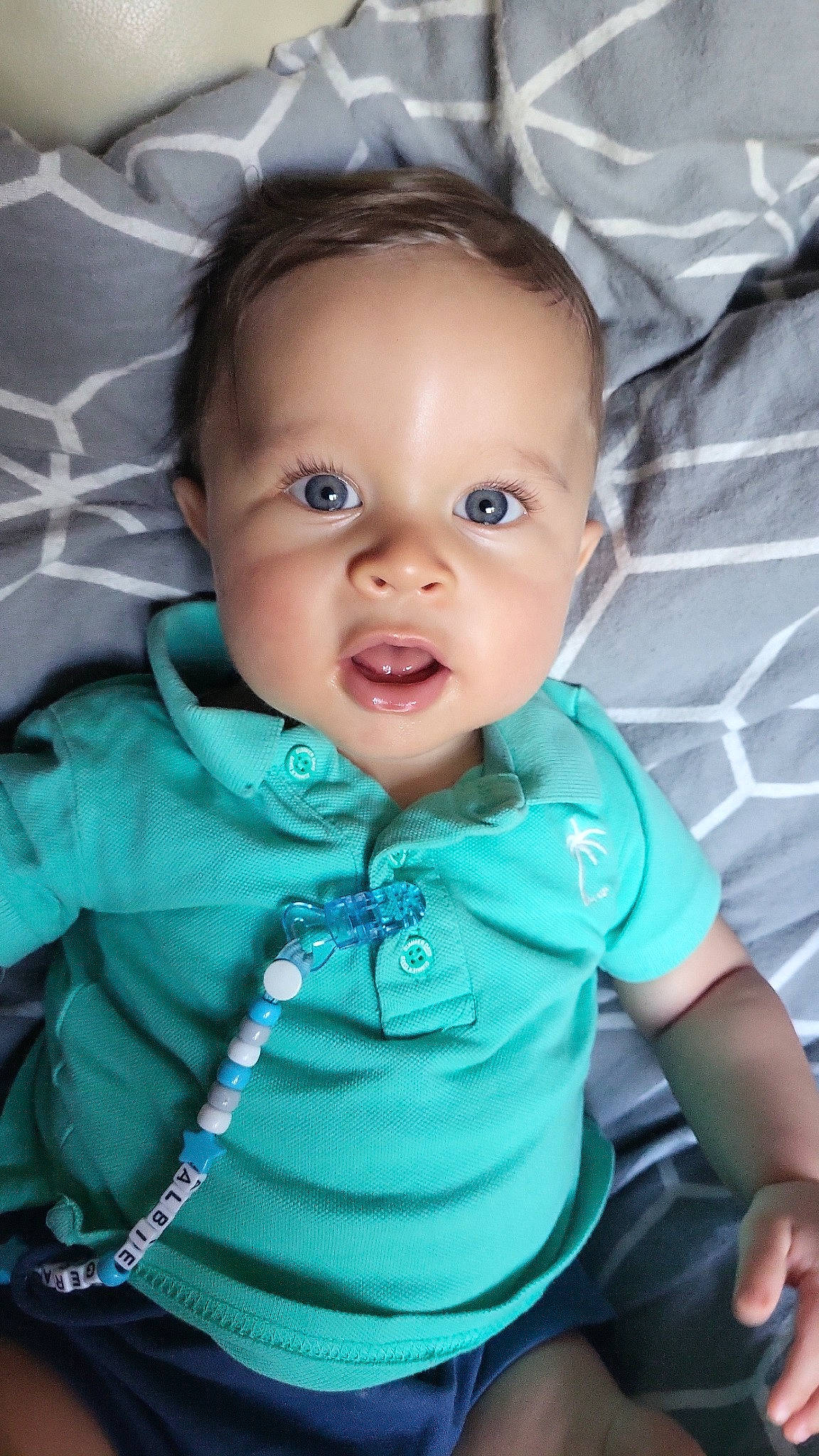 Albie is registered to the contest to win money with this photo: baby, baby_toddler_clothing, cheek, child, comfort, electric_blue, eyebrow, eyelash, flash_photography, happy, iris, lip, mouth, nose, person, product, skin, sleeve, smile, t_shirt