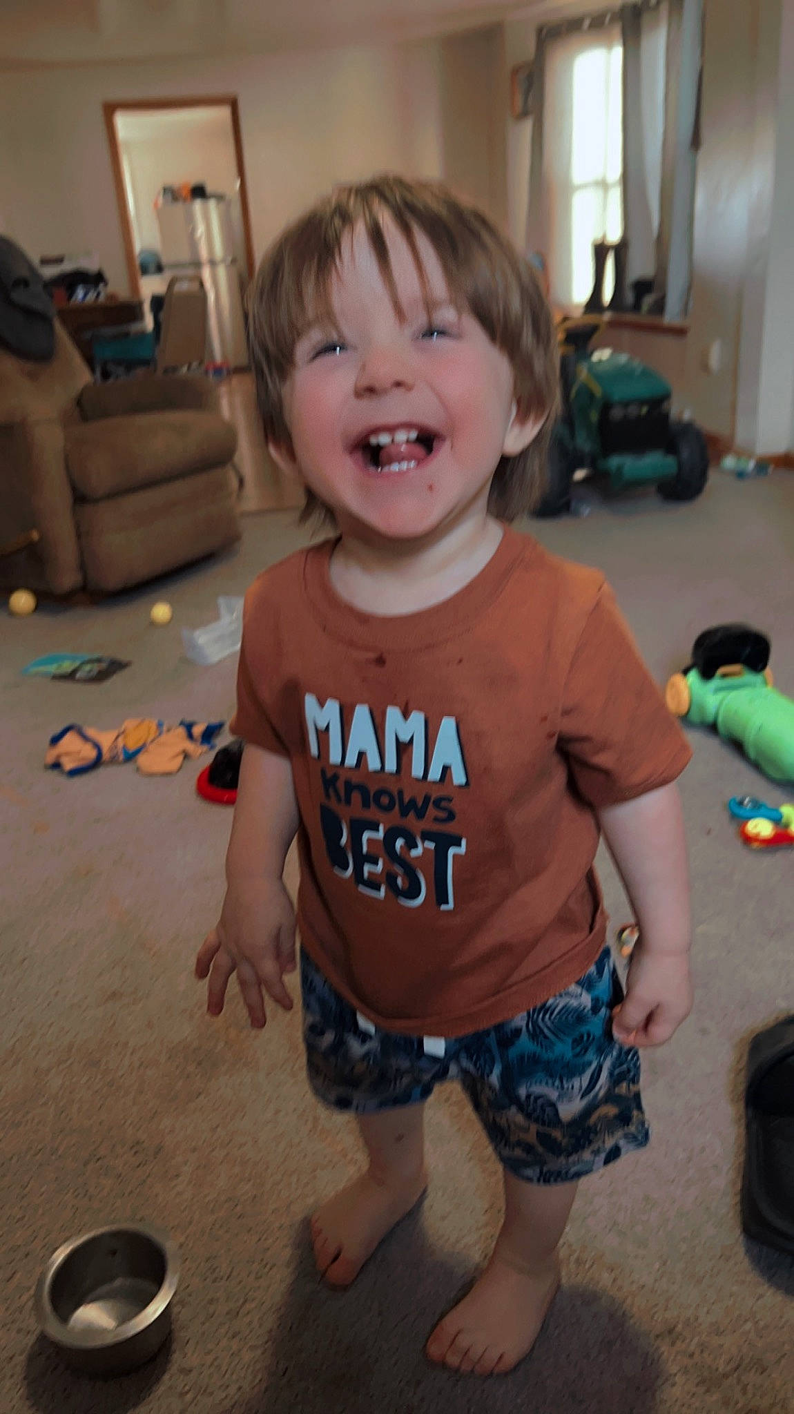 Bentley is registered to the contest to win money with this photo: baby, baby_toddler_clothing, cheek, child, facial_expression, floor, flooring, fun, happy, head, human_leg, iris, joint, person, shorts, skin, sleeve, smile, t_shirt, thigh