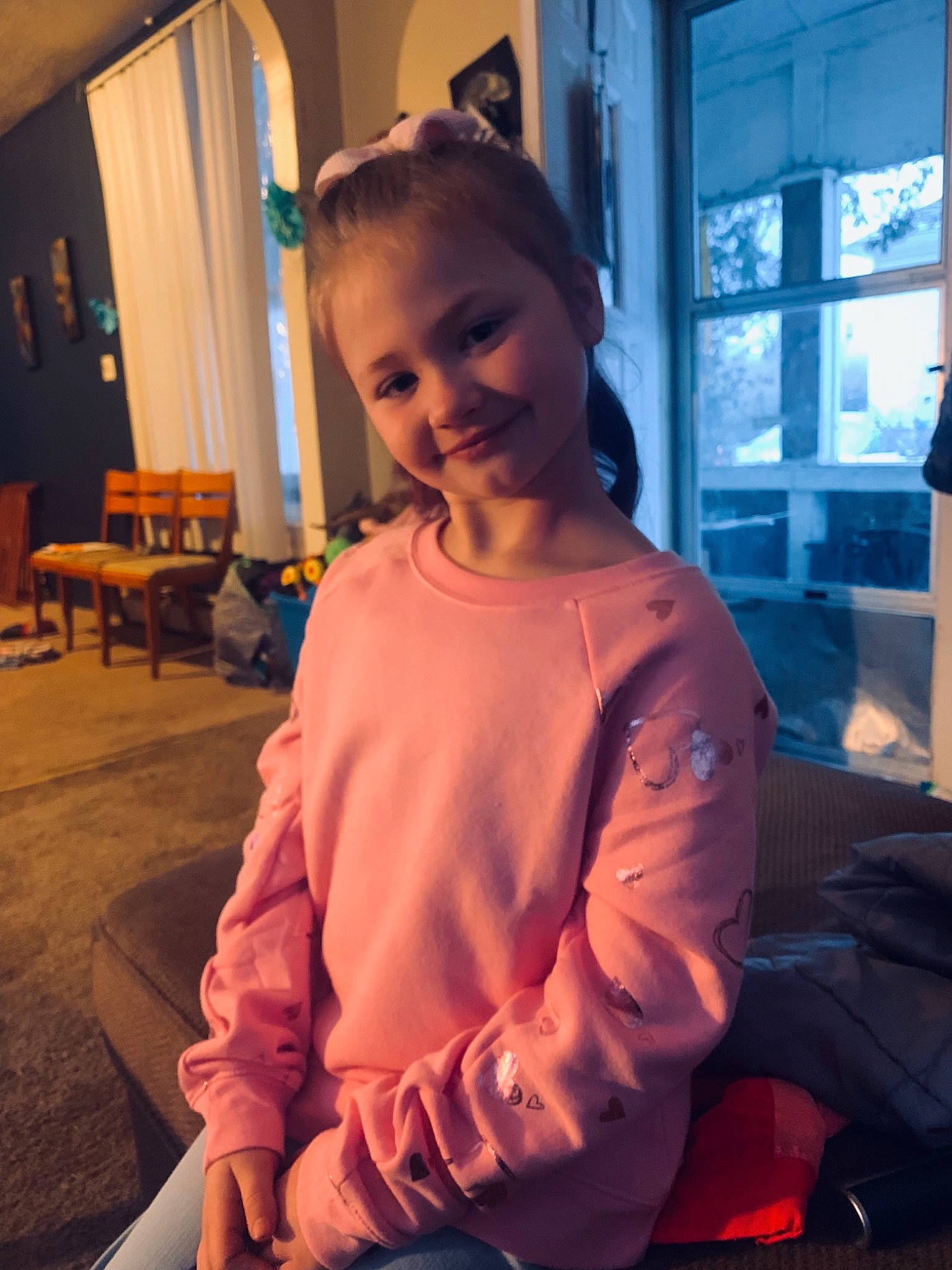 Aaliyah is registered to the contest to win money with this photo: chair, child, cool, curtain, electric_blue, event, flooring, fun, happy, joy, laugh, leisure, mouth, person, room, shoulder, sitting, sleeve, smile, t_shirt