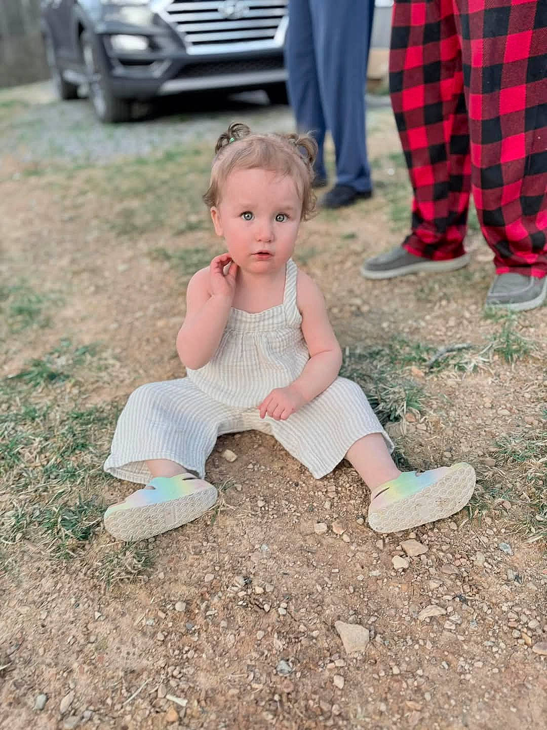 Natalee is registered to the contest to win money with this photo: baby, clothing, dress, face, footwear, grass, head, machine, pants, person, photography, plant, portrait, sandal, shoe, sitting, tire, transportation, vehicle, wheel