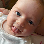 Logan joined the competition — help win amazing prizes! baby, infant, tongue_out, blue_eyes, white_clothing, cute, face, smiling, person, child, portrait, cheeky, indoors, closeup, skin, young, head, expression, happy, playful