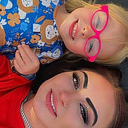 Everlee joined the competition — help win amazing prizes! child, adult, glasses, smile, face, portrait, lying_down, makeup, eyebrows, blond_hair, brown_hair, shirt, pattern, lion_pattern, red_clothing, happy, person, outdoor, closeup, jewelry