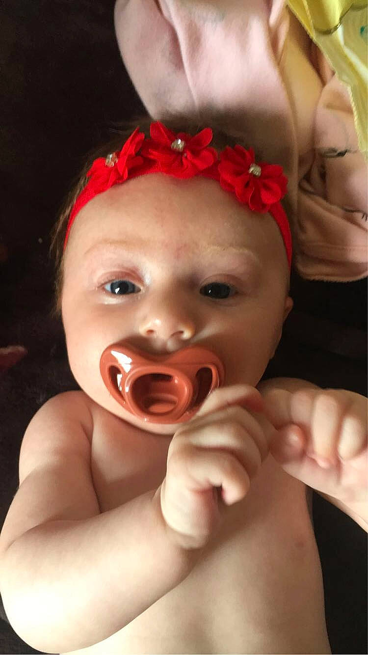 Emberlynn is registered to the contest to win money with this photo: baby, cheek, chin, eye, eyebrow, eyelash, finger, flash_photography, gesture, hair, happy, human_body, iris, lip, mouth, neck, nose, person, pink, skin