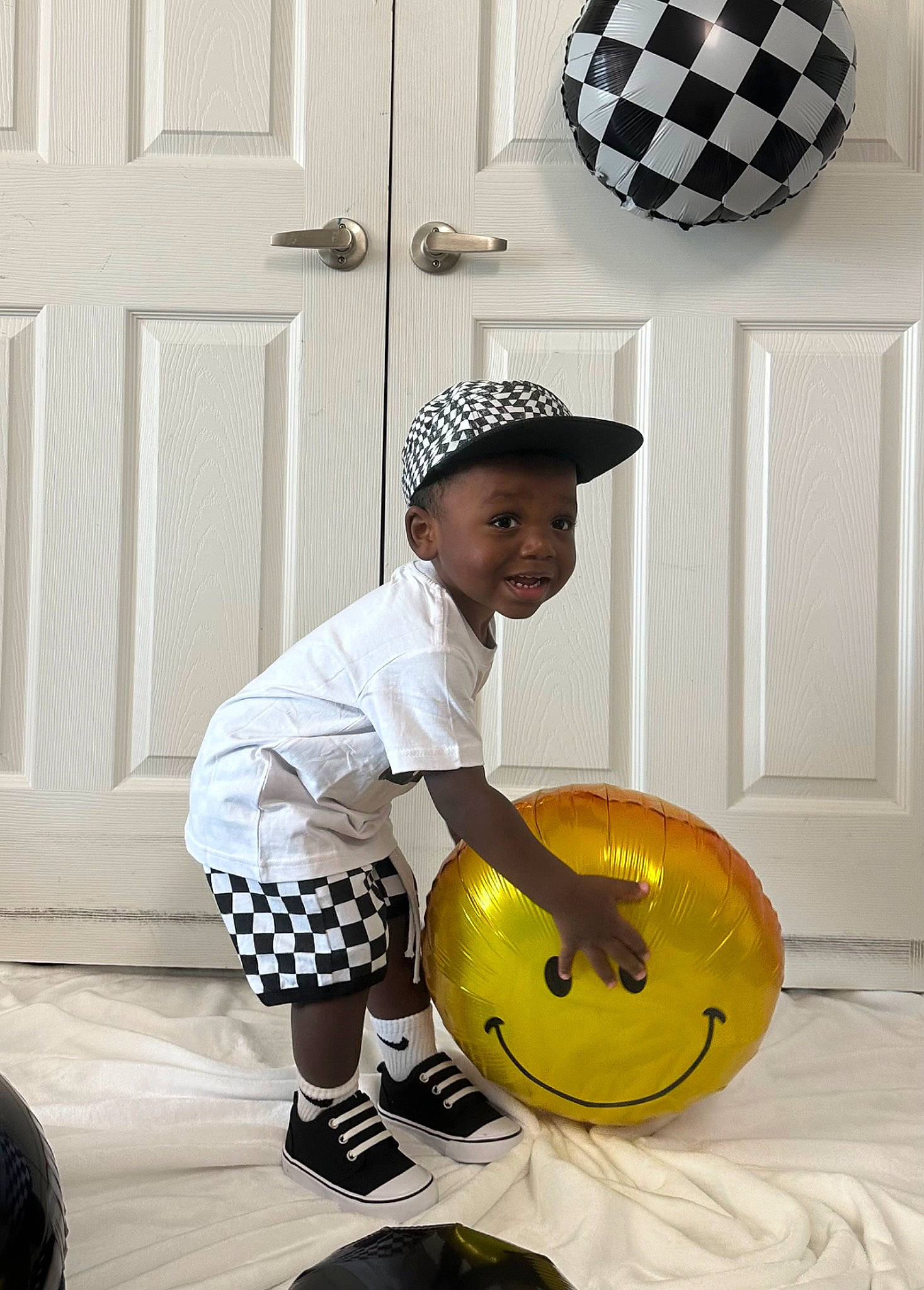 Brayden is registered to the contest to win money with this photo: art, baby_toddler_clothing, ball, cap, child, door, fashion_accessory, flooring, happy, hat, headwear, musical_instrument, pattern, person, personal_protective_equipment, sitting, smile, sun_hat, t_shirt, toddler