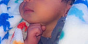 Josiah is registered to the contest to win money with this photo: baby, sleeping, blanket, soft, colorful, cozy, child, cute, face, hand, curly_hair, infant, portrait, peaceful, indoors, warm, resting, newborn, snuggled, toddler