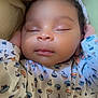 baby, sleeping, infant, onesie, patterned_clothing, sailboats, parachutes, hands, face, closed_eyes, blanket, cute, peaceful, soft_light, indoors, portrait, child, newborn, cozy, resting