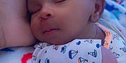 Josiah joined the competition — help win amazing prizes! baby, blanket, child, closeup, comfort, cozy, curly_hair, cute, dinosaur_pattern, indoor, infant, newborn, onesie, peaceful, portrait, resting, sailboat_pattern, sleeping, soft_texture, warm