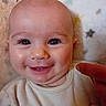 baby, smile, face, eyes, finger, blanket, stars, close_up, infant, cute, child, cheeks, expression, soft_texture, happy, portrait, skin, clothing, person, young