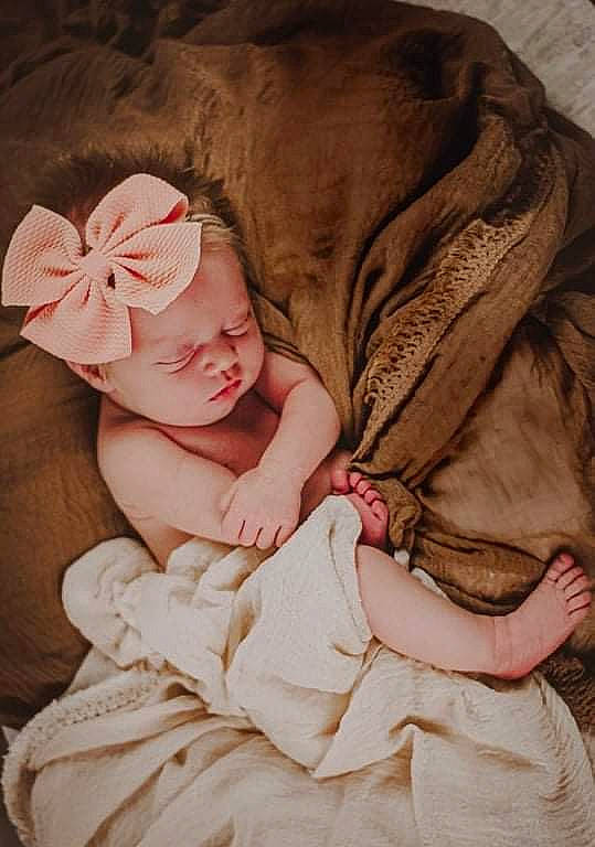 Kinzlee is registered to the contest to win money with this photo: baby, baby_products, baby_sleeping, baby_toddler_clothing, cheek, child, comfort, fashion_accessory, flesh, hand, headband, headpiece, linens, lip, peach, person, pink, sitting, skin, sleeve