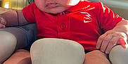 David joined the competition — help win amazing prizes! baby, infant, child, red_shirt, converse_shoes, sneakers, seat, cushion, indoor, sunlight, hand, footwear, portrait, young_child, casual_clothing, soft_light, curious, cute, comfortable, baby_seat