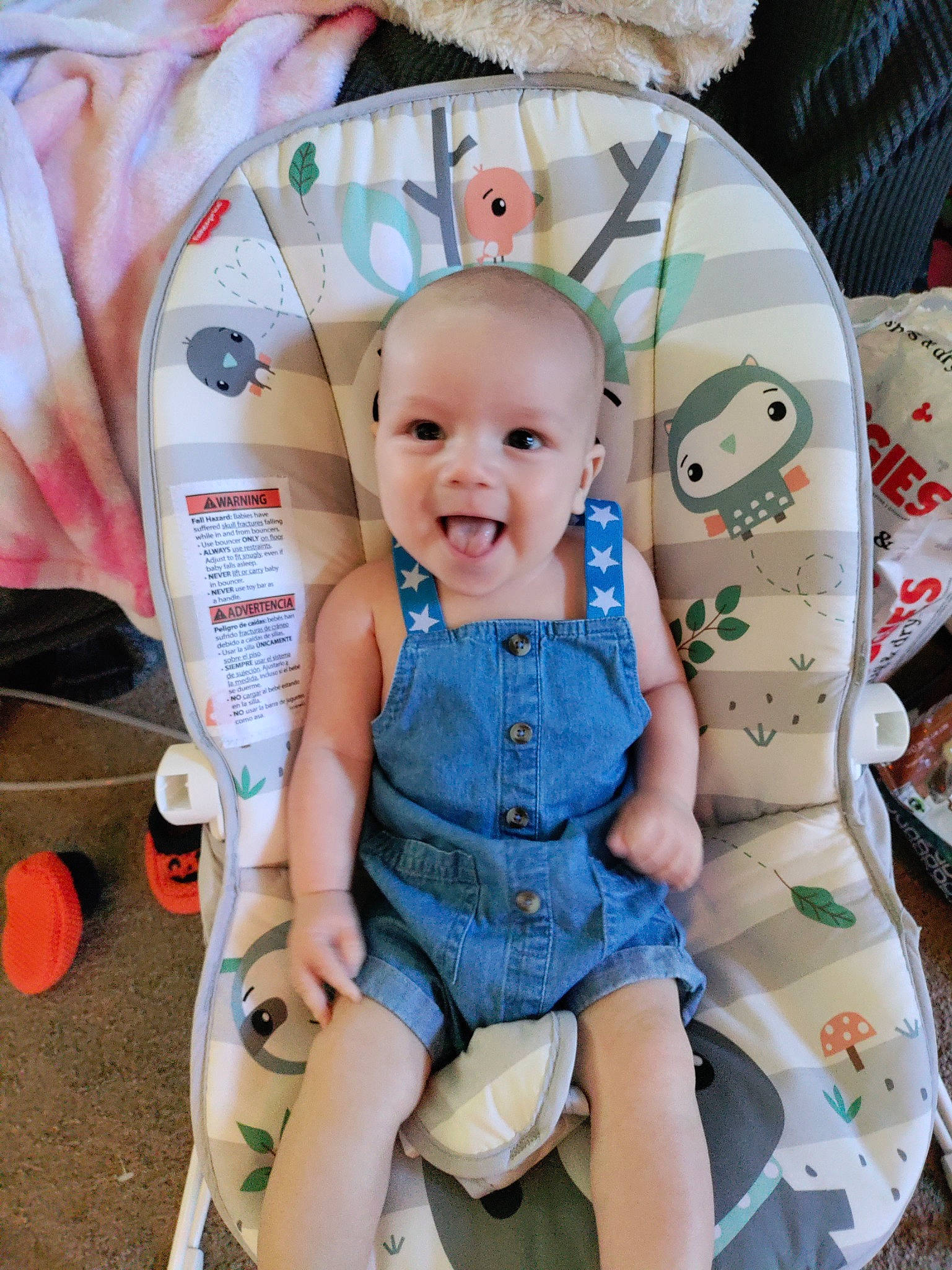 Augustus is registered to the contest to win money with this photo: baby, baby_products, baby_toddler_clothing, chair, child, electric_blue, fashion_accessory, fun, happy, pattern, person, pink, room, shorts, sitting, smile, textile, thigh, toddler, vacation