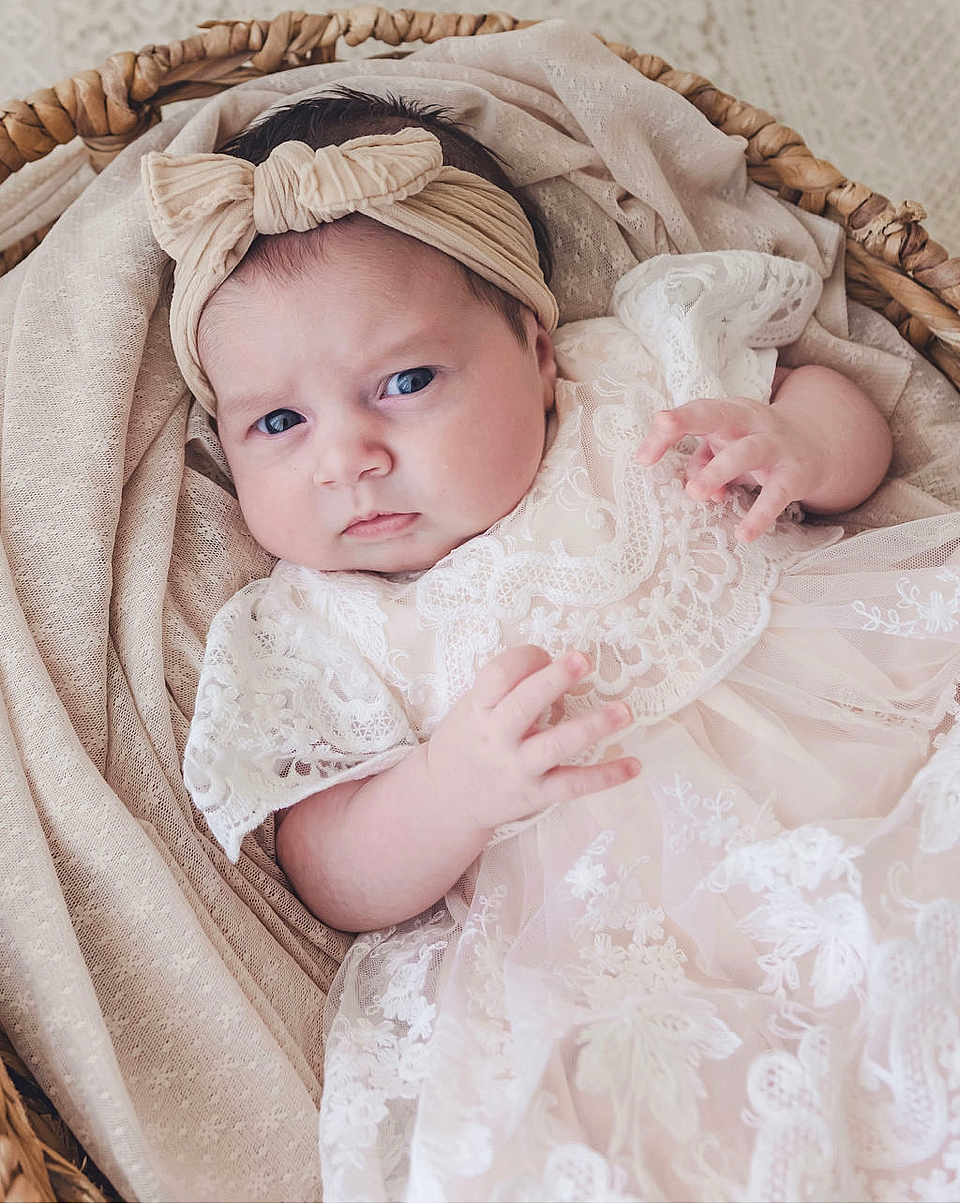Arabella joined the competition — help win amazing prizes! baby, infant, headband, bow, lace, dress, basket, fabric, cloth, portrait, cute, child, newborn, person, face, hand, skin, indoor, soft, expression