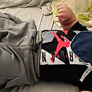 Ethan joined the competition — help win amazing prizes! baby, infant, child, bed, blanket, pillow, clothing, pants, shirt, beanie, bib, lying_down, indoor, cute, face, expression, soft, comfort, casual, resting