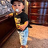 Elias is registered to the contest to win money with this photo: toddler, child, baby, portrait, standing, pacifier, cap, hat, shirt, jeans, shorts, sneakers, shoes, bedroom, dresser, bed, carpet, indoors, sunlight, smiling