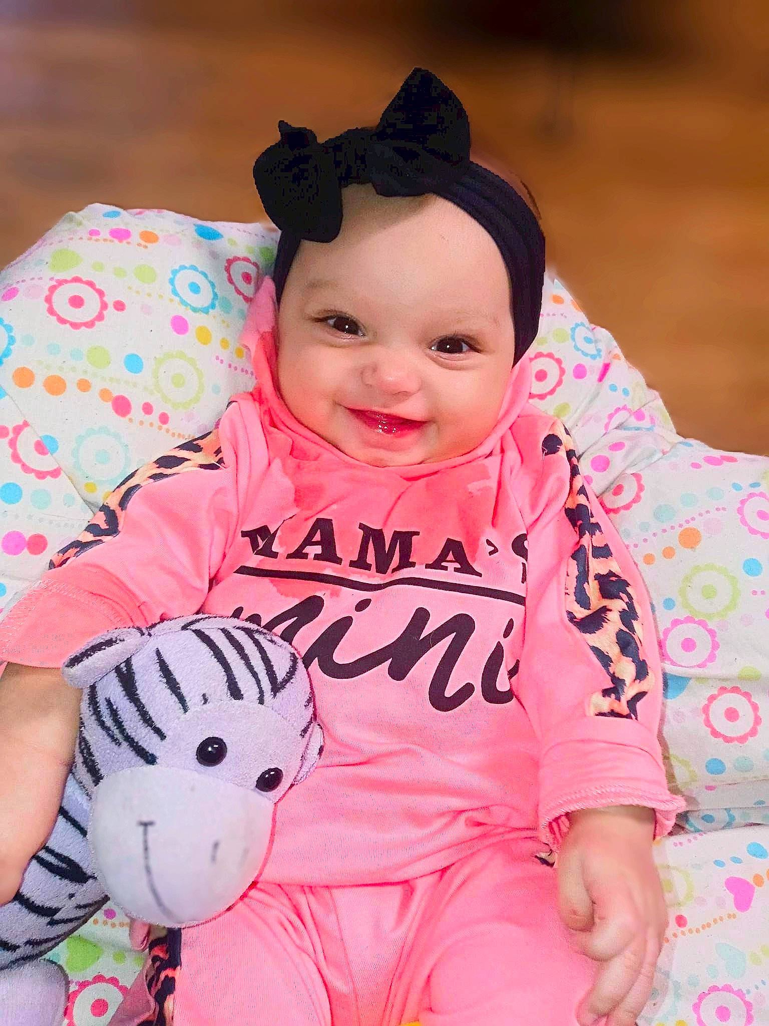 Calliope is registered to the contest to win money with this photo: baby, baby_toddler_clothing, cheek, child, comfort, facial_expression, fun, happy, head, joy, magenta, mammal, person, pink, product, skin, sleeve, smile, t_shirt, textile