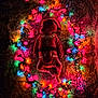 baby, infant, christmas_lights, festive, holiday, santa_outfit, sleeping, soft_texture, colorful_lights, glowing, cute, cozy, warm_lighting, child, holiday_decor, celebration, lying_down, nighttime, indoors, cute_baby