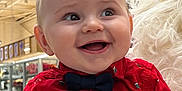 Milo a rejoint le concours — aidez-le/la à gagner de superbes lots ! baby, child, smiling, red_shirt, bow_tie, indoor, holiday, decoration, reindeer, person, white_gloves, festive, happy, cute, face, portrait, holding, toy, christmas, celebration