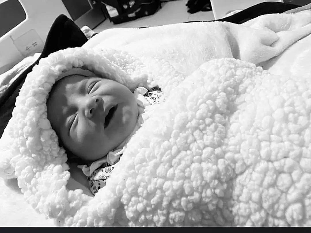 Alina is registered to the contest to win money with this photo: baby, baby_sleeping, bedding, bedtime, black, black_and_white, child, close_up, comfort, fur, happy, headwear, linens, monochrome, monochrome_photography, nose, person, smile, style, textile