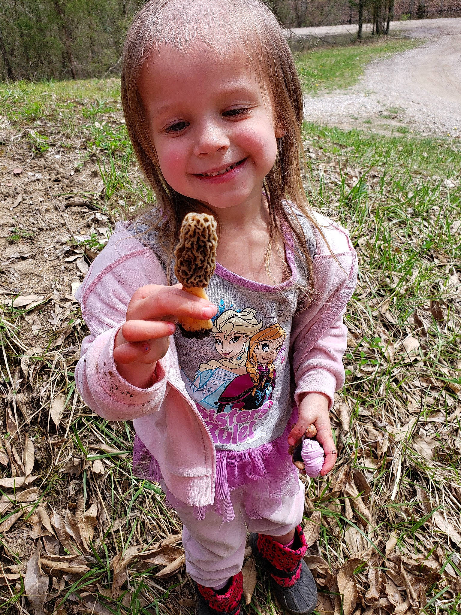 Laney is registered to the contest to win money with this photo: child, false_morel, finger, joy, person, plant, play, smile, soil, thumb, toddler