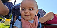 Dalton joined the competition — help win amazing prizes! baby, child, stroller, bib, outdoor, sunlight, grass, man, woman, sunglasses, cap, smile, portrait, people, casual_clothing, happy, daylight, family, park, baby_bib