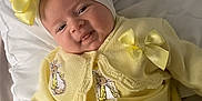 Dolce-Mai is registered to the contest to win money with this photo: baby, infant, smile, yellow_outfit, bow, headband, bunny_patch, bed, pillow, blanket, cute, baby_clothes, soft_lighting, indoor, portrait, baby_girl, happy, child, newborn, cozy