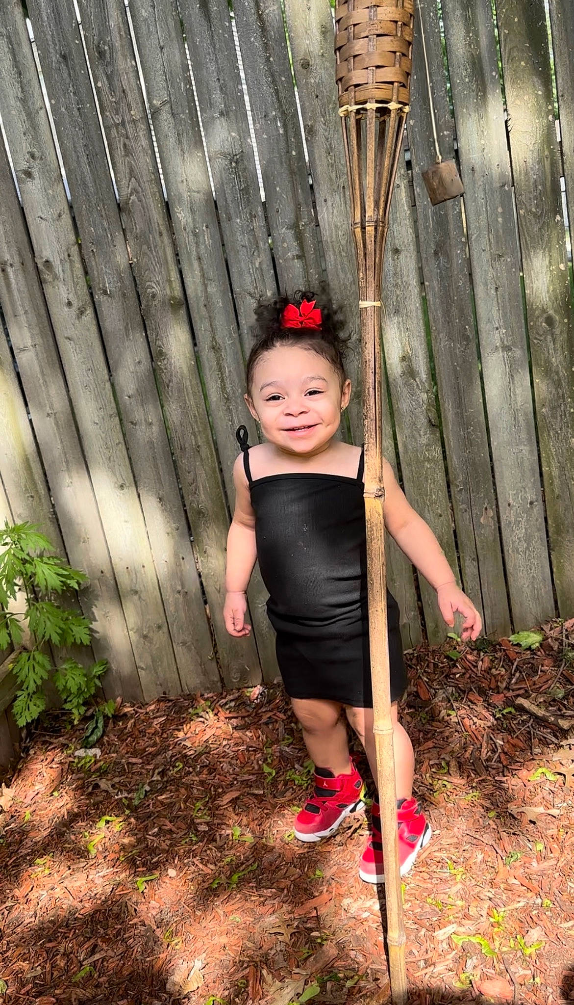 Armani is registered to the contest to win money with this photo: child, day_dress, dress, face, flash_photography, formal_wear, grass, hair, happy, human_leg, joy, magenta, one_piece_garment, people_in_nature, person, plant, sandal, t_shirt, tints_and_shades, toddler