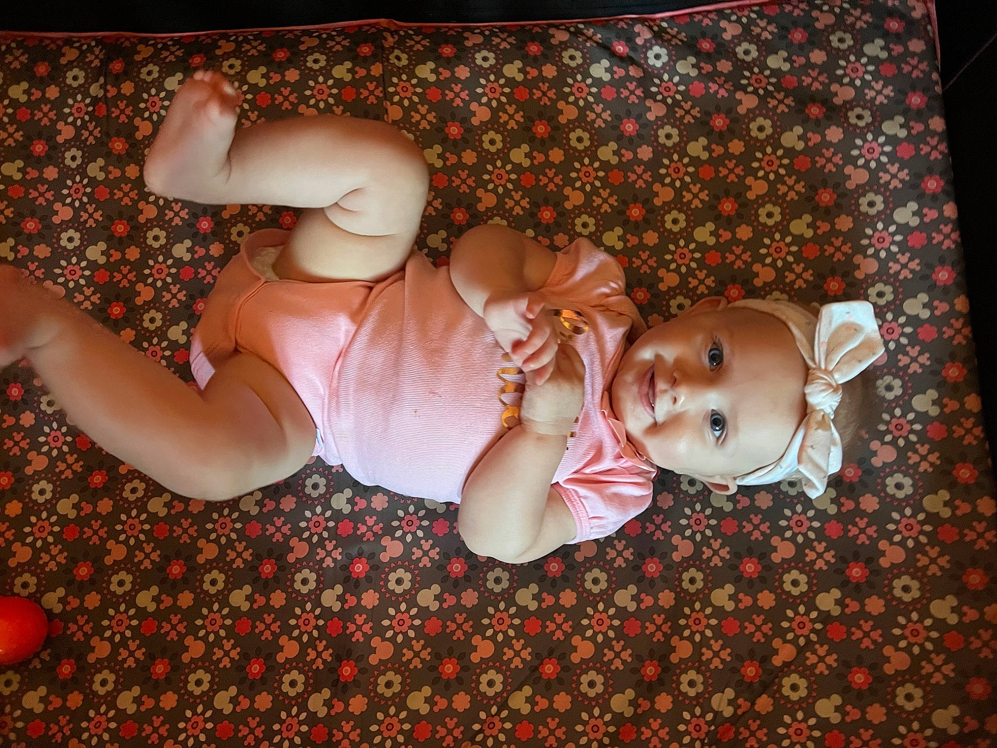 Gracelynn is registered to the contest to win money with this photo: baby, carmine, chest, child, flower, fun, grass, happy, headwear, human_body, human_leg, joy, leg, pattern, people_in_nature, person, petal, pink, plant, smile