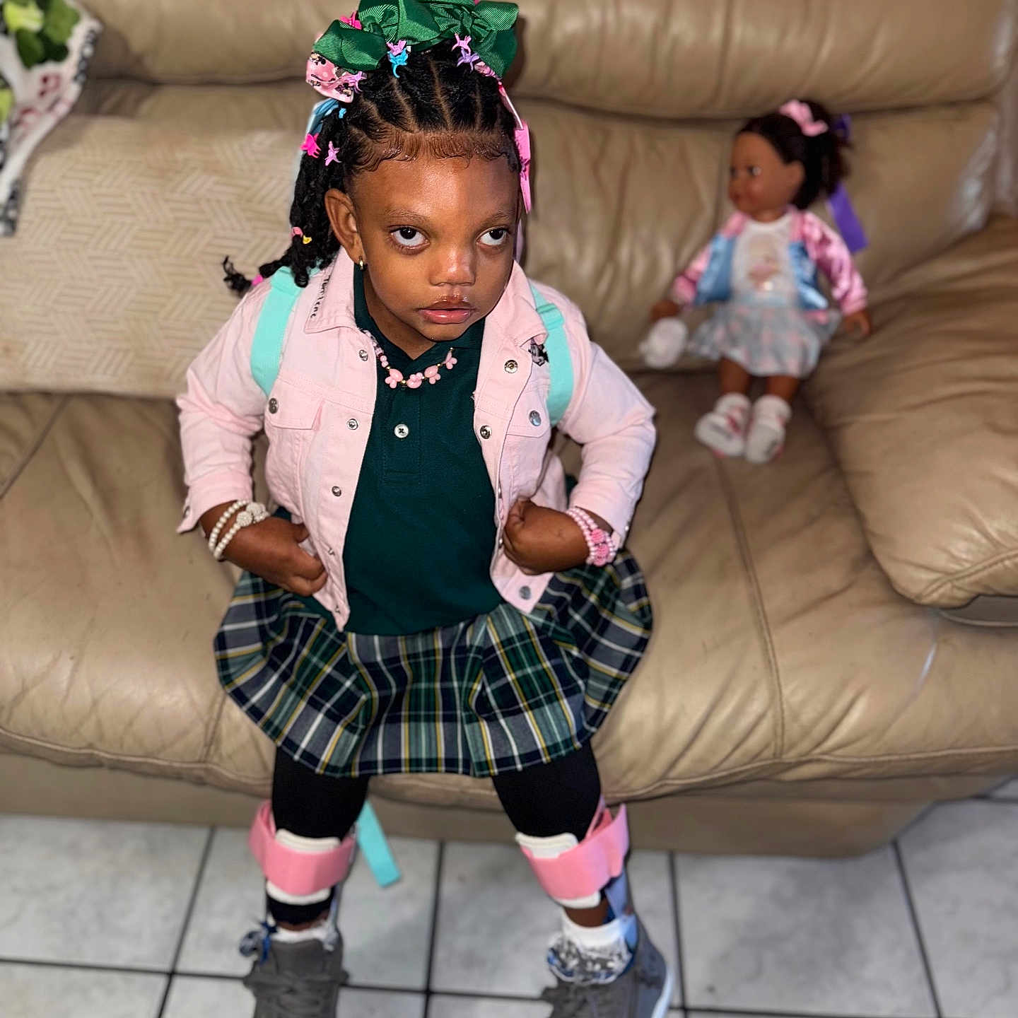 Tonlene Godqueen joined the competition — help win amazing prizes! accessories, black_tights, bracelets, child, confident, doll, fashion, girl, hair_bows, home, indoor, leather_couch, person, pink_jacket, plaid_skirt, portrait, seated_doll, sneakers, tile_floor, toy
