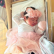 Natalia is registered to the contest to win money with this photo: newborn, baby, sleeping, pink_tutu, headband, hospital_bassinet, white_clothing, mittens, blanket, soft_lighting, infant, cute, peaceful, resting, indoor, portrait, small, delicate, cozy, tulle